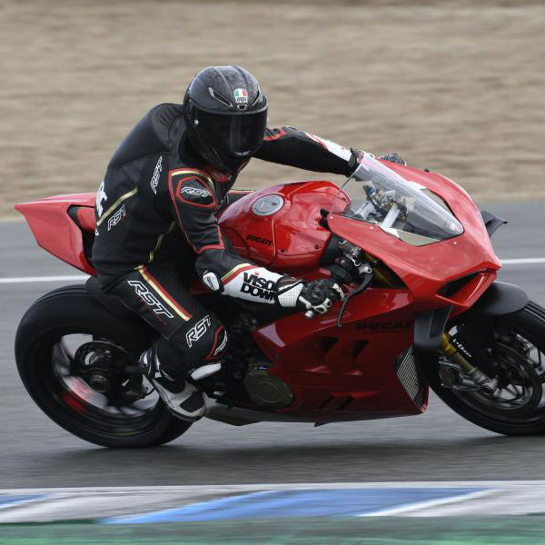 A red 2022 Ducati Panigale V4S being ridden around a racetrack